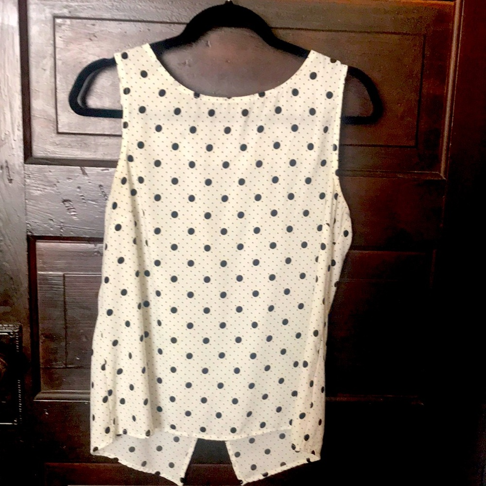 Sleeveless black and cream polka dot blouse